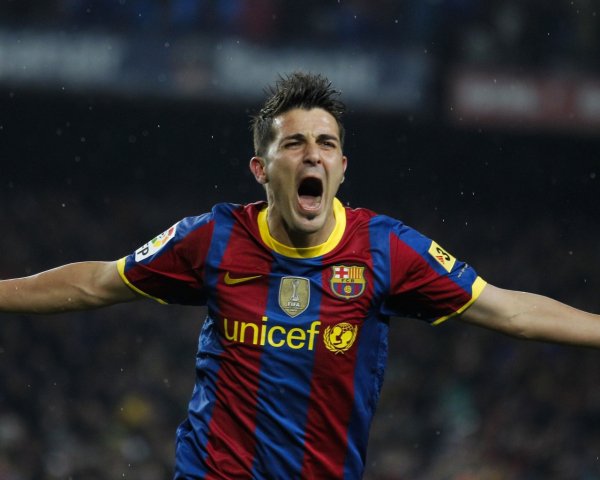 Football player David Villa rejoices with a goal scored