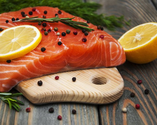 Food Seafood A piece of red fish with lemon and black p