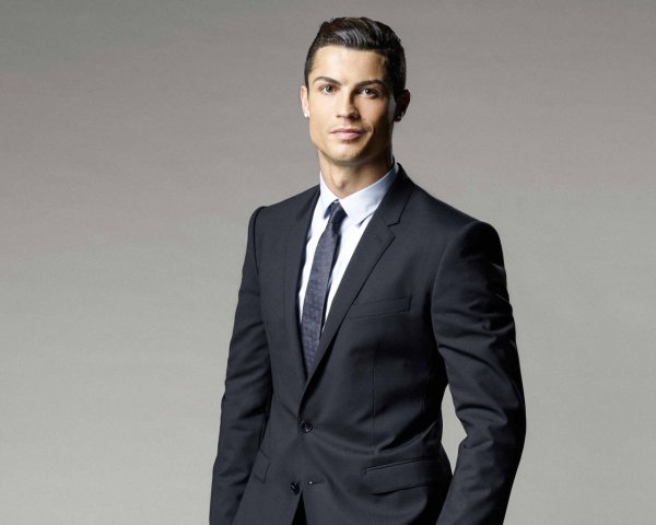 Soccer player Cristiano Ronaldo in a suit on a gray back
