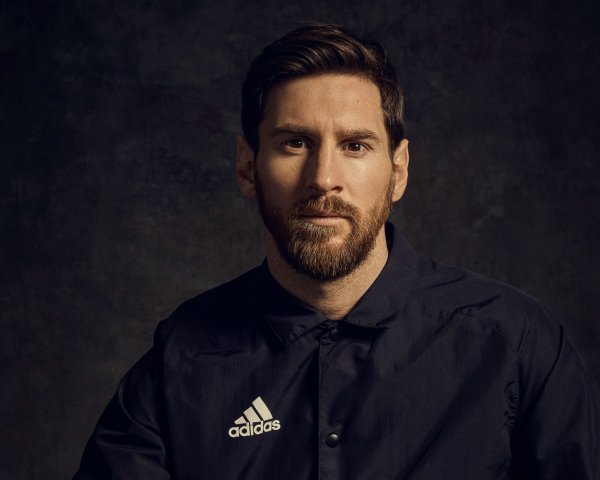 Football player Lionel Messi in a black shirt with a bea