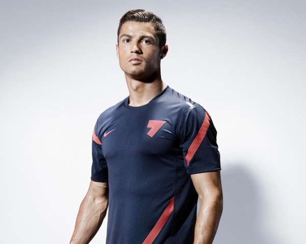 Handsome man soccer player Cristiano Ronaldo on a gray