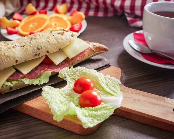 Food Sandwiches on a table with fruits and a cup of tea 1