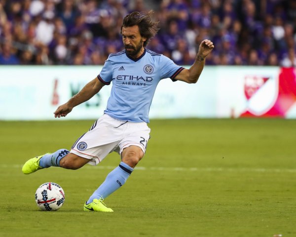Football player Andrea Pirlo on the field with the ball