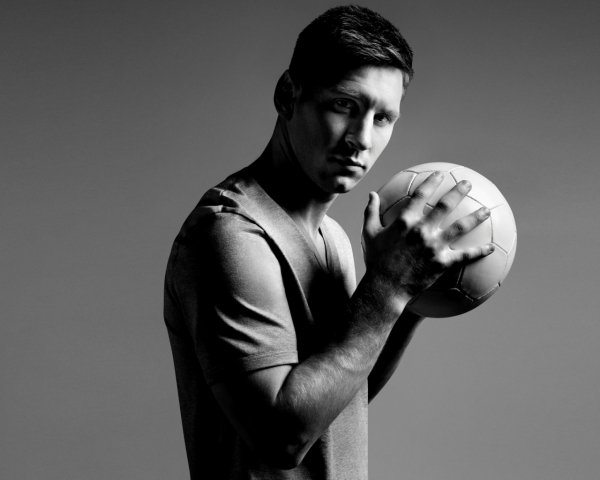 Football player Lionel Messi with the ball in his hands