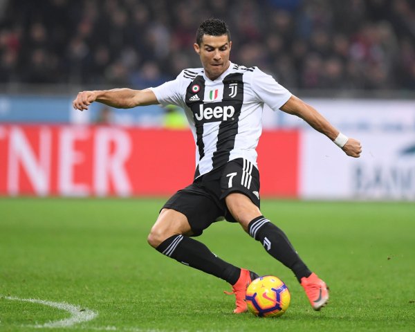 Football player Cristiano Ronaldo takes ball away on foo