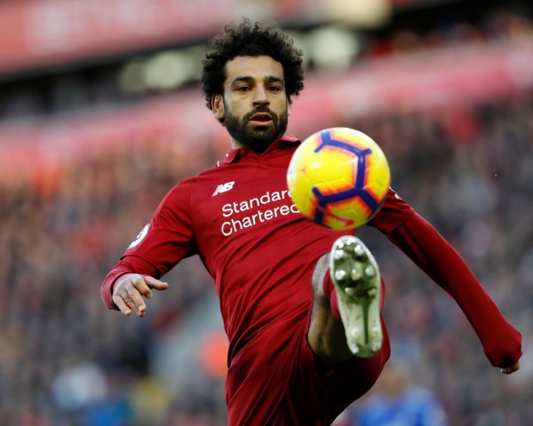 Egyptian football player Mohammed Salah beats off the ba