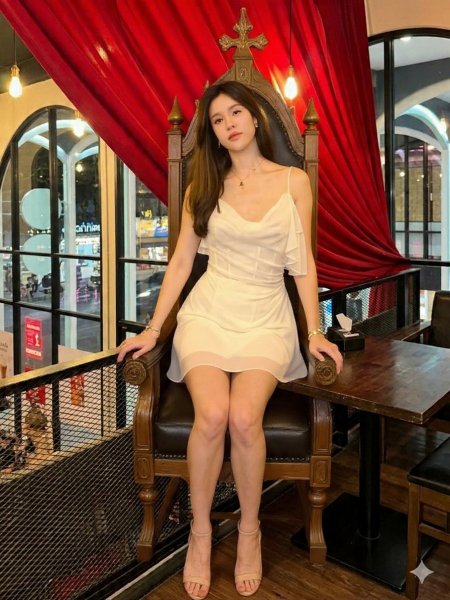 Make-the-woman-sit-on-the-black-chair-next-to-the-